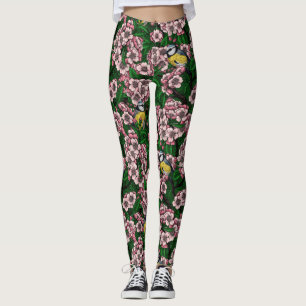 Blue tit birds in the blooming cherry tree on gree leggings
