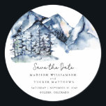 Blue Watercolor Mountain Rustic Boho Save the Date Classic Round Sticker<br><div class="desc">Blue Watercolor Mountain Rustic Boho Save the Date Square Sticker featuring a gorgeous watercolor mountain landscape with tall evergreen pine trees, handwritten script and modern typography for a clean, minimalist feel. If the location of your wedding is a longer city and state than what we have here, the square stickers...</div>
