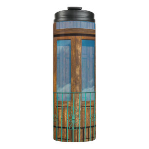 Blue wooden door on yellow concrete building thermal tumbler