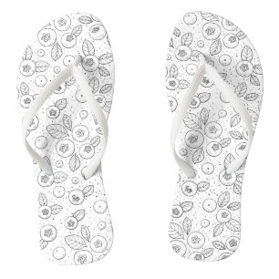 Blueberries on black and white flip flops