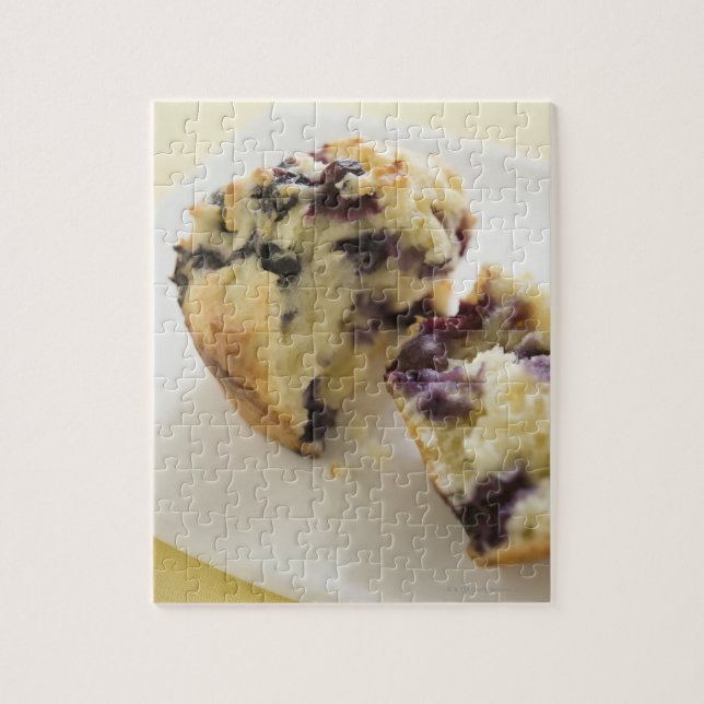 Blueberry muffin split open on a white plate jigsaw puzzle (Vertical)