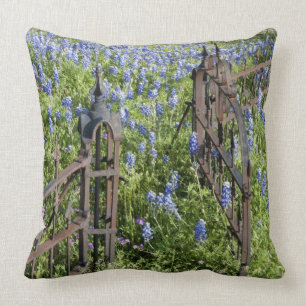 Bluebonnets and phlox surrounding cemetery gate throw pillow