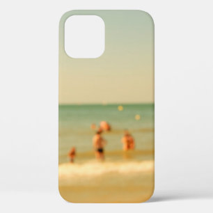 Blurred beach photo with bokeh. People relaxing on iPhone 12 Case