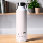Blush Pink Elegant Modern Minimalist Monogram Name Water Bottle<br><div class="desc">Elevate your hydration routine with our Classic Elegant Modern Minimalist Monogram Black Water Bottle. Meticulously designed, this water bottle seamlessly merges timeless sophistication with contemporary minimalism, making it a stylish and functional accessory for your daily life. Crafted with precision and attention to detail, this water bottle is more than just...</div>