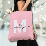 Blush Pink Elegant Script Name Monogram Tote Bag<br><div class="desc">Personalized Girly Blush Pink and White Trendy Modern Script Name Monogram Tote Bag. Add a soft and feminine touch to your everyday style with this chic and playful tote bag. Featuring a blush pink background and a bold white initial (with no shimmer or foil), paired with a sleek black script...</div>
