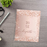 Blush rose gold glitter dust monogram name 2025 planner<br><div class="desc">A rose gold background with elegant blush faux glitter dust. Personalize and add a year (upside down) and add a name. The name is written in dark rose gold with a large modern hand lettered style script with swashes. Perfect for school, work or organizing your personal/family life. To keep the...</div>