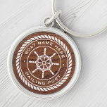 Boat name hailing port nautical ship's wheel wood keychain<br><div class="desc">Keyring featuring a white,  elegant ship's wheel and rope emblem with custom boat name and hailing port (or other custom text) on a printed image of brown wood.</div>