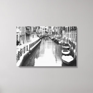 Boats along a canal in the Italian city of Venice Canvas Print
