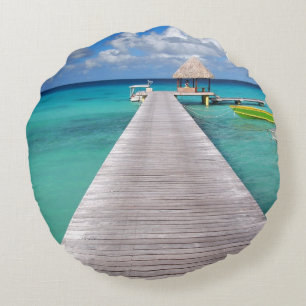 Boats at a jetty in the Pacific round throw pillow