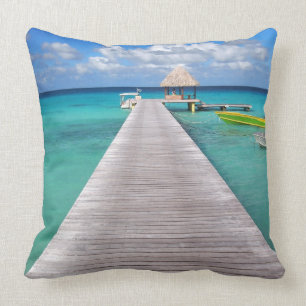 Boats at a jetty in the Pacific throw pillow