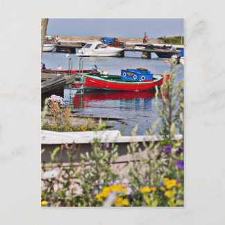 Boats docked in small harbour postcard