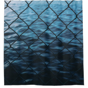 Body of water in front of chain link fence