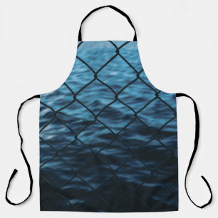 Body of water in front of chain link fence apron