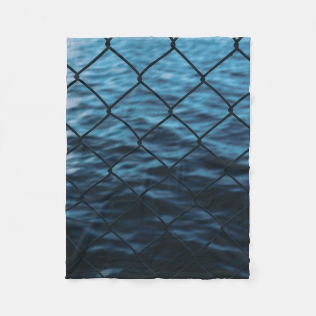 Body of water in front of chain link fence fleece blanket (Front)