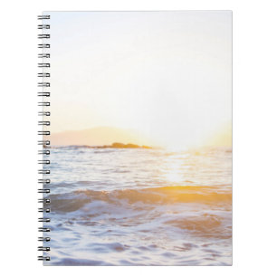 Body of water under sunset notebook