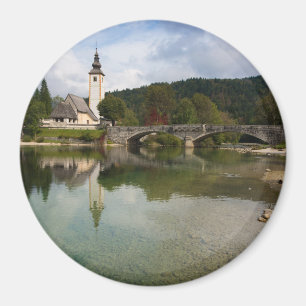 Bohinj lake with church in Slovenia round magnet