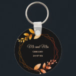 Boho autumn botanical gold frame wedding keychain<br><div class="desc">Set against a striking black background, this keychain features apricot-coloured text that provides a warm and inviting touch. Delicate leaves in soft muted earth tones and earthy autumnal copper shades evoke the cozy charm of autumn, while the geometric frame in burnt orange and terracotta adds a rustic yet sophisticated flair....</div>