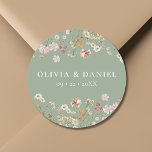 Boho Wildflower Sage Green Garden Wedding Classic Round Sticker<br><div class="desc">Add a charming touch to your wedding stationery or favours with our Boho Wildflower Garden Wedding Classic Round Sticker. Featuring delicate wildflower illustrations on a soft beige background, this versatile sticker is perfect for sealing envelopes, adorning favour bags, or adding a personal touch to decor. Its elegant design complements a...</div>