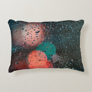Bokeh photography of water droplets on clear glass accent pillow