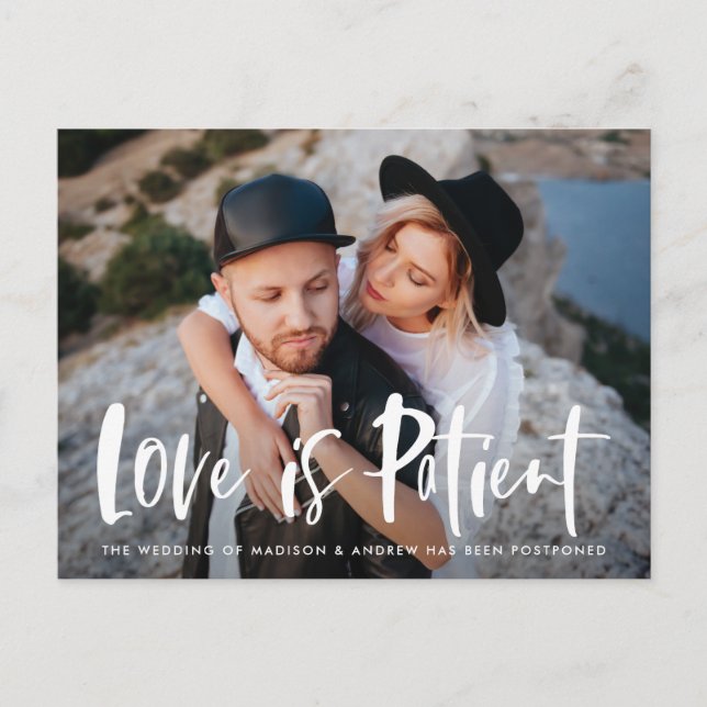 Bold Brush Script Love is Patient Postponement Announcement Postcard (Front)