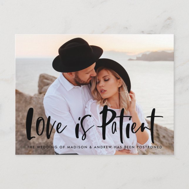 Bold Brush Script Love is Patient Postponement Announcement Postcard (Front)