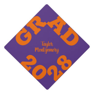 Bold GRAD Orange on Purple Graduation Cap Topper