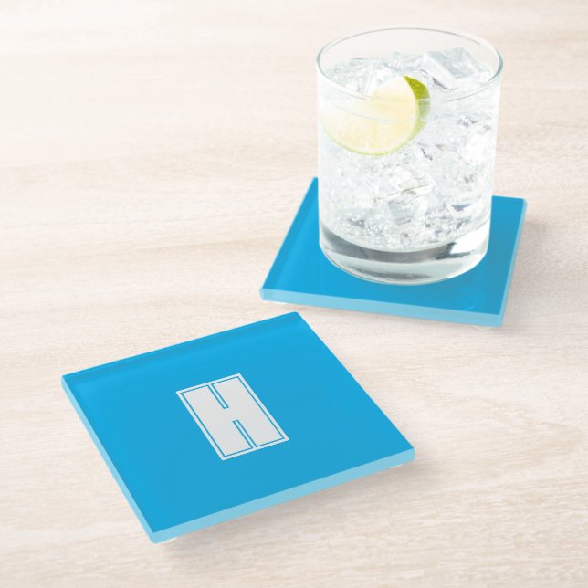 Bold white initial bright blue glass coaster (Angled)