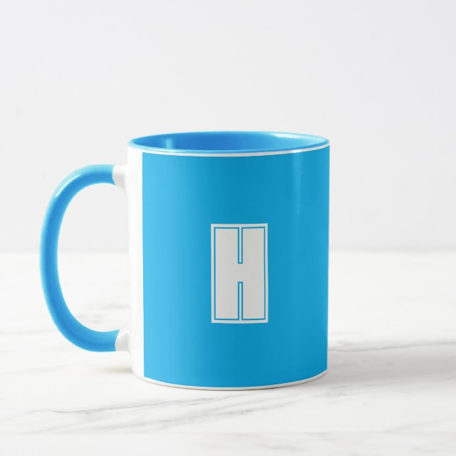 Bold white initial bright blue mug (Left)