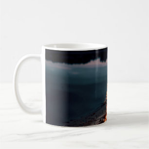 Bonfire near body of water during night time coffee mug