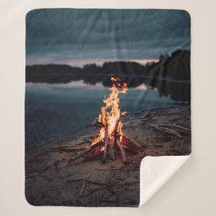 Bonfire near body of water during night time sherpa blanket