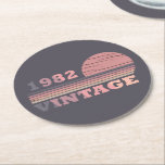 born in 1982 vintage birthday gift round paper coaster<br><div class="desc">You can add some originality to your wardrobe with this modern and elegant purple and pink colour sunset vintage retro-looking birthday design with awesome typography font lettering, it is a great gift idea for women, wives, and girlfriends who will love this one-of-a-kind artwork. The best and most fun holiday present...</div>