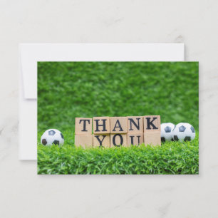 Boule de football avec Merci de mot sur herbe vert