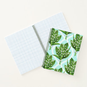 Bouquet of lilly of the valley flowers on blue notebook