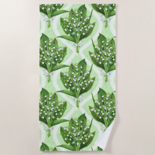Bouquet of lilly of the valley flowers on green beach towel
