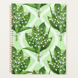Bouquet of lilly of the valley flowers on green planner