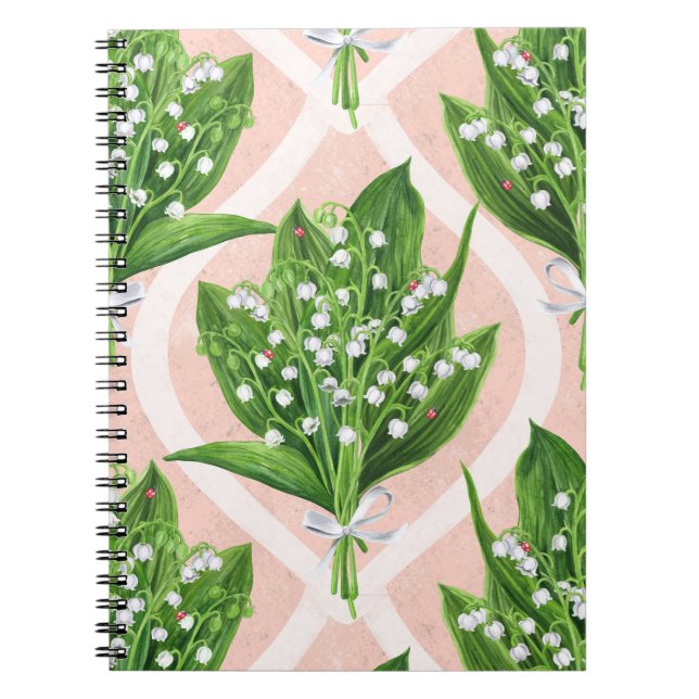 Bouquet of lilly of the valley flowers on pink notebook (Front)
