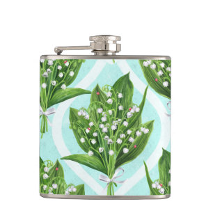 Bouquet of lily of the valley flowers on blue hip flask