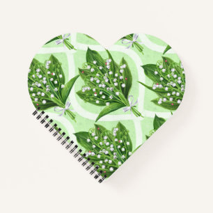 Bouquet of lily of the valley flowers on blue notebook