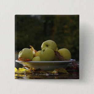 Bowl of apples and leaves 2 inch square button
