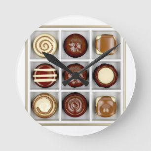 Box with chocolate candies round clock