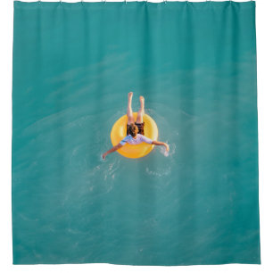 Boy sitting on buoy