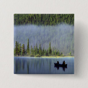 Boys fishing from canoe with mist in 2 inch square button