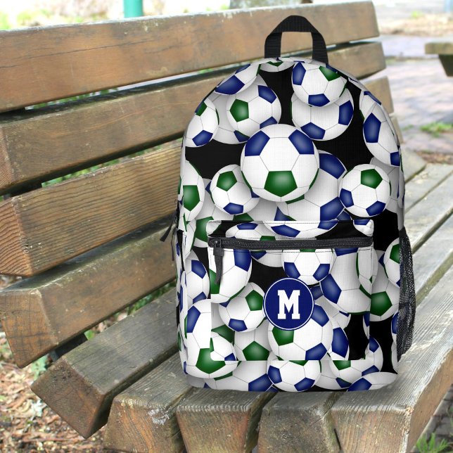 boys girls soccer player blue green team colours printed backpack (on outdoor bench)