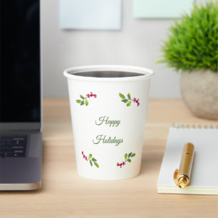 Brach of holly berries and leaves  paper cups