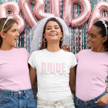 Bride T-Shirt | Personalized Future Mrs. Name<br><div class="desc">This modern and personalized Bride T-Shirt is the perfect outfit for any bride-to-be! Featuring soft blush pink “BRIDE” text paired with elegant handwritten “future Mrs. [Your Name]” below, this tee is ideal for bridal showers, bachelorette parties, wedding prep, and honeymoon travel. Available in multiple styles and fits for every bride’s...</div>