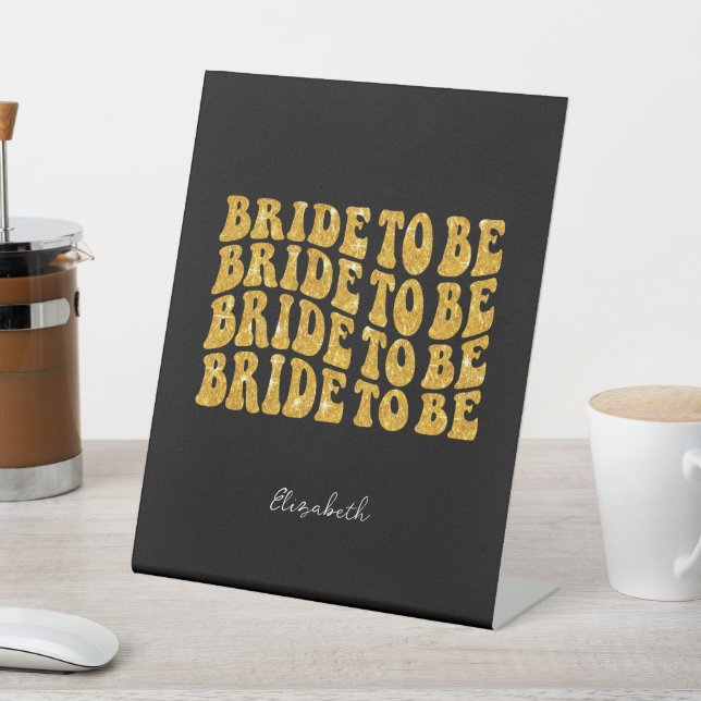 Bride to Be Gold Glitter Text with Name, Black Pedestal Sign (In SItu)