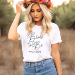 Bride to Be Script Calligraphy Name T-Shirt<br><div class="desc">Celebrate the bride-to-be with this gorgeous script calligraphy tee featuring "Bride to Be" in flowing hand-lettered typography and a customizable first name. A beautiful monogram keepsake for engagement parties,  bridal showers,  and bachelorette weekends. Edit the name to personalize for the guest of honour.</div>