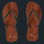 Bride Wedding Day Rustic Wood Look Beach Honeymoon Flip Flops<br><div class="desc">Rustic wood look bride flip flop thong sandals perfect for beach weddings- Reads Bride in elegant style, pastel pink letters at the bottom. Elegant, rich mahogany wood look woodgrain pattern background. Note: Wood is printed image. Rustic wedding favours for bridal party members. Just change text templates to create your own...</div>