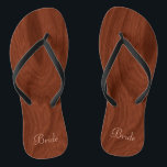 Bride Wedding Day Rustic Wood Look Beach Honeymoon Flip Flops<br><div class="desc">Rustic wood look bride flip flop thong sandals perfect for beach weddings- Reads Bride in elegant style, pastel pink letters at the bottom. Elegant, rich mahogany wood look woodgrain pattern background. Note: Wood is printed image. Rustic wedding favours for bridal party members. Just change text templates to create your own...</div>