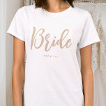 Bride Wedding Personalized Name Beige White T-Shirt<br><div class="desc">Celebrate the bride-to-be with a unique custom t-shirt! A simple and stylish design featuring trendy script lettering,  and personalized with the bride's name,  wedding date,  location or other text. This stylish beige and white t-shirt,  makes a lovely gift for a bachelorette party,  wedding shower or celebration weekend!</div>
